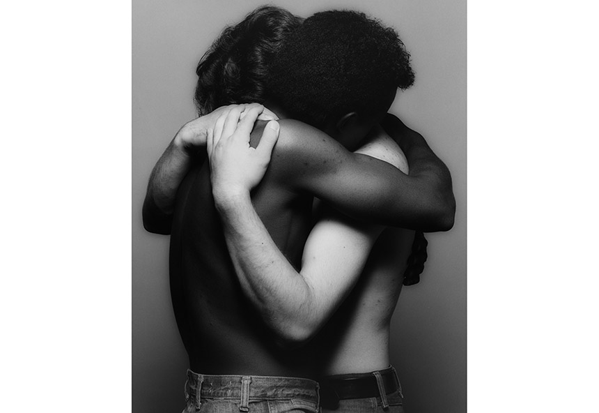 a white and black man hugging